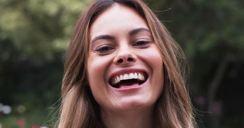 Joyful Woman Laughing Outdoors in Natural Setting