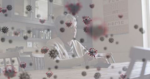 Elderly woman using device at home with virus overlay effect