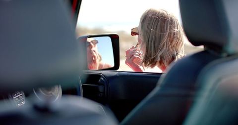 Woman Uses Smartphone Next to Car on Sunny Road Trip - Download Free Stock Images Pikwizard.com