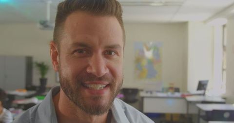 Encouraging male teacher in bright classroom environment