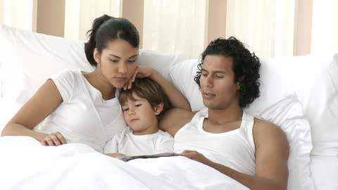 Family Bonding: Parents Reading with Child in Bed