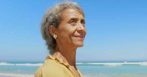 Thoughtful Senior Woman at Sunny Beach