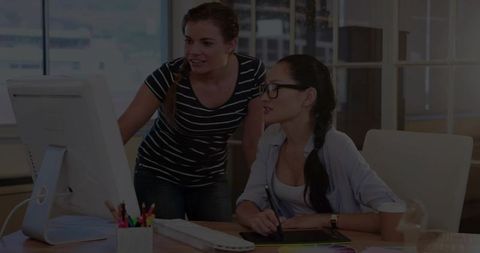 Professional Women Collaborating on Digital Design at Modern Office