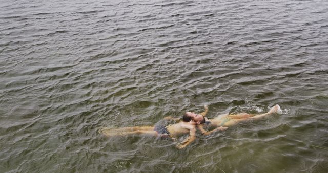 Couple Enjoying a Refreshing Swim in a Calm Lake - Download Free Stock Photos Pikwizard.com