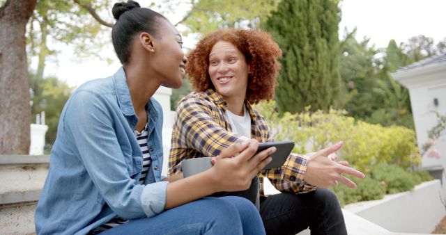 Young Friends Relaxing Outdoors Sharing Tablet and Smiling - Download Free Stock Images Pikwizard.com