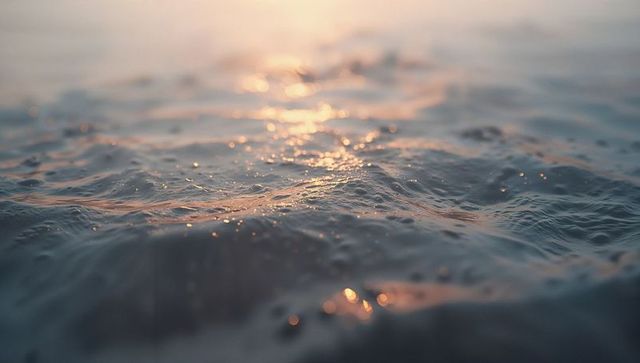 Glistening Water Surface with Ripples and Sunlight Reflections