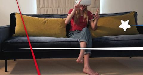 Young woman wearing vr headset on sofa enjoying immersive home virtual reality experience