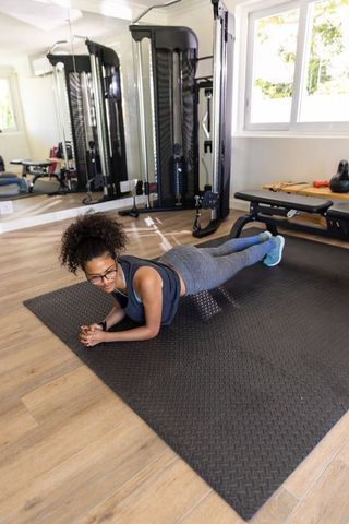 Woman Planking in Home Gym for Fitness and Strength Training