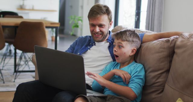 Father and Son Excitedly Watching on Laptop at Home - Download Free Stock Images Pikwizard.com