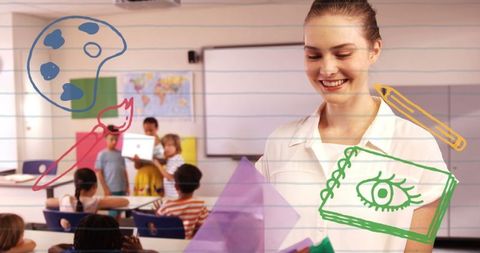Smiling female teacher in classroom with classroom drawings