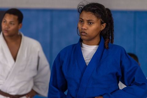 Focused Judo Practitioners Training in Gym Wearing Traditional Gis