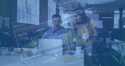 Coworkers Engaging with Futuristic Digital Data Interface in Office