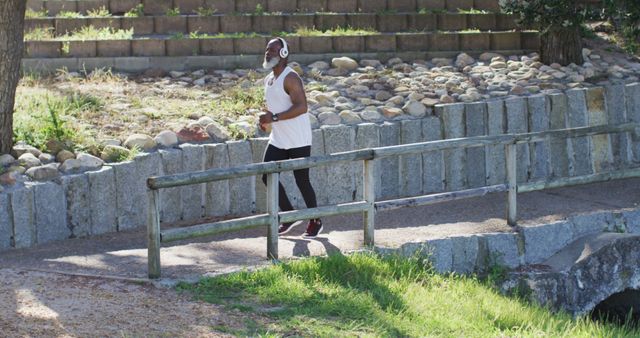 Man Jogging Outdoors in Park Listening to Music - Download Free Stock Images Pikwizard.com