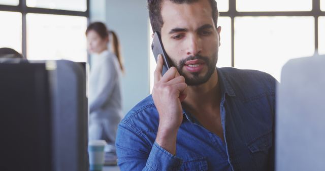 Focused Professional Man Talking on Phone in Modern Office - Download Free Stock Images Pikwizard.com