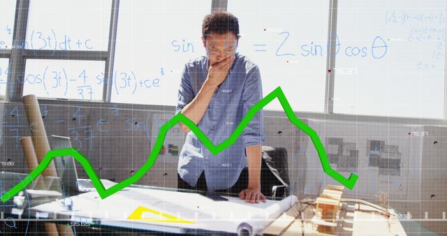 Image of a green graph forming on a grid with mathematical formulae floating over Caucasian man standing by a table with multiple papers on it. Finance and technology concept digital composite