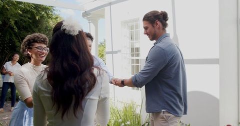 Couple Exchanging Vows Outdoors with Smiling Guests