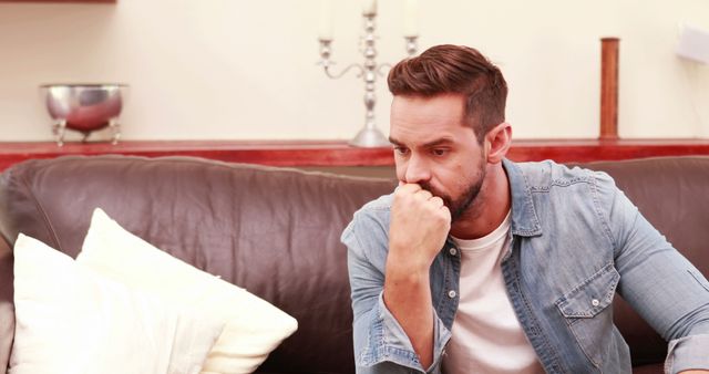 Thoughtful Man Sitting on Sofa in Living Room - Download Free Stock Images Pikwizard.com