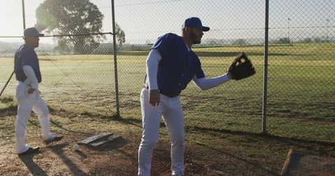Baseball Players Preparing for Game at Sunrise