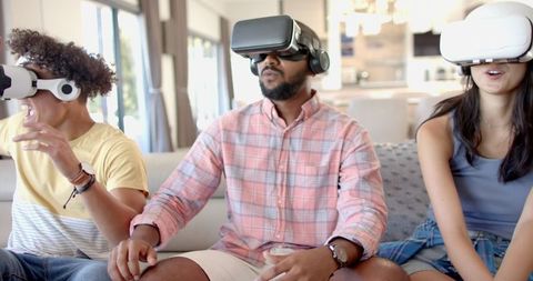 Diverse Friends Engaging in Virtual Reality Gaming at Home