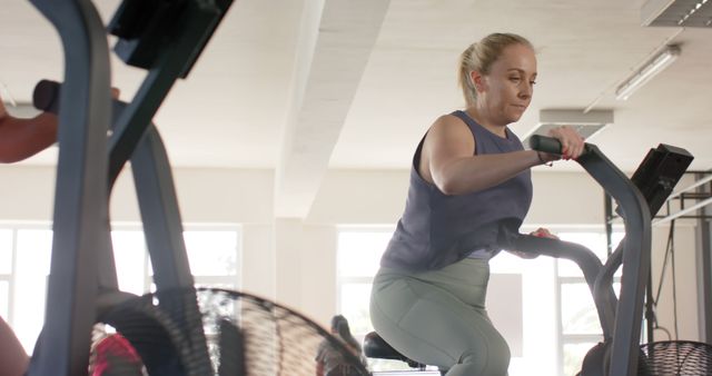 Woman Exercising on Elliptical Machine in Gym - Download Free Stock Images Pikwizard.com