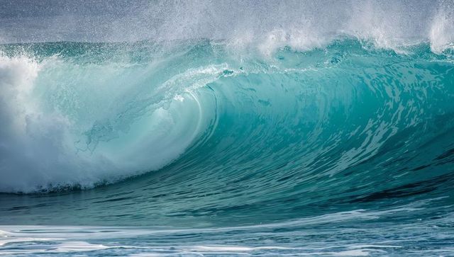 Turquoise Barrel Wave Curling and Breaking with Crest Spray and Sea Foam
