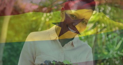 Joyful african woman holding fresh harvest in herbal garden