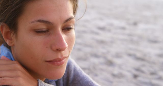 Woman Relaxing by Ocean with Serene Expression - Download Free Stock Images Pikwizard.com