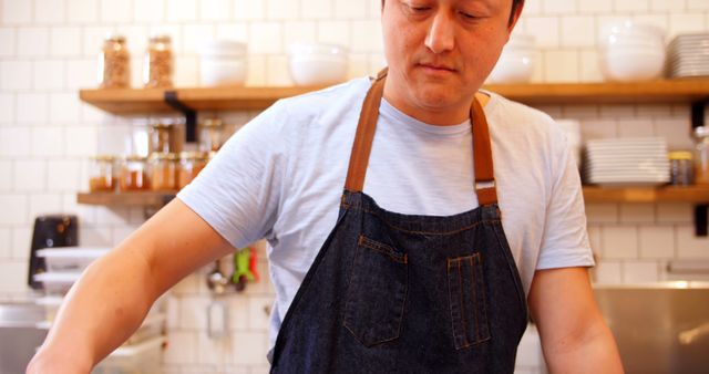 Male Chef in Denim Apron Preparing Food in Modern Kitchen - Download Free Stock Images Pikwizard.com