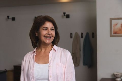 Elegant Woman Smiling in Minimalist Home Interior