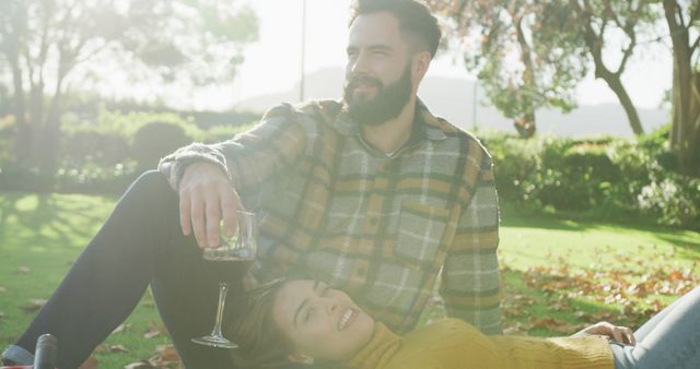 Romantic Couple Relaxing Outdoors with Wine in Sunny Park - Download Free Stock Images Pikwizard.com