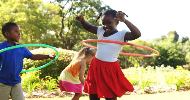 Happy Children Playing with Hula Hoops in Park on Sunny Day - Download Free Stock Images Pikwizard.com