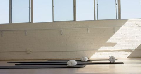 Bright yoga studio with mats and towels ready for class