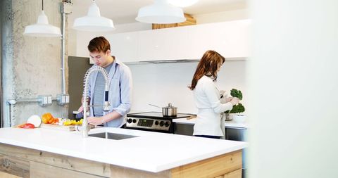 Young Couple Preparing Fresh Meal Together in Modern Kitchen - Download Free Stock Images Pikwizard.com