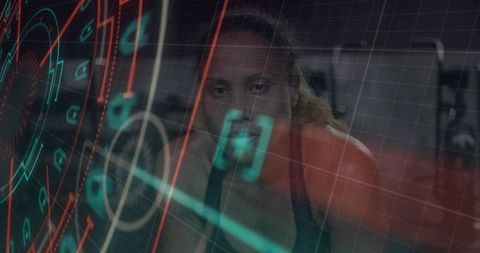 Female athlete peering through translucent hud while training with futuristic fitness interface