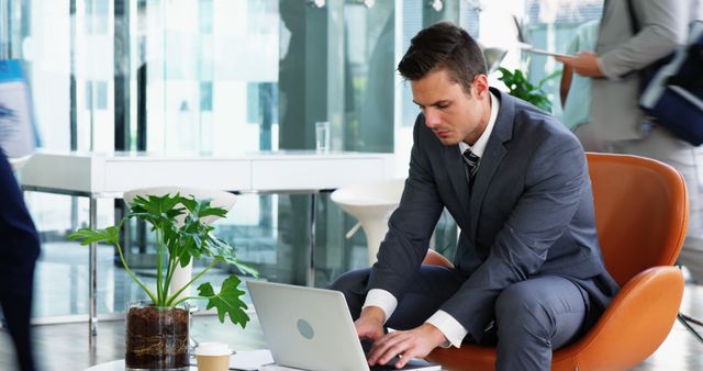 Businessman Working on Laptop in Modern Office Lounge - Download Free Stock Images Pikwizard.com