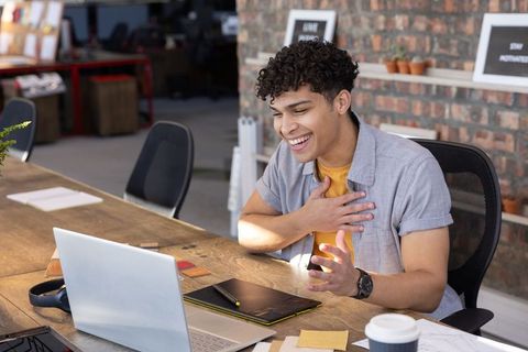 Young Professional Engaged in Virtual Meeting from Creative Office