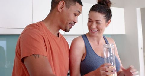 Diverse Couple Making Smoothie Together in Modern Kitchen