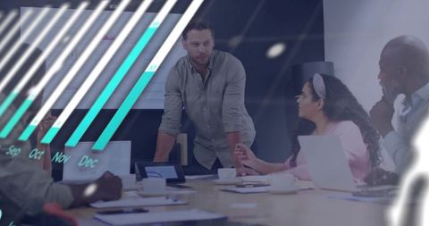 Team leader presenting strategy with projected chart and laptop in boardroom meeting