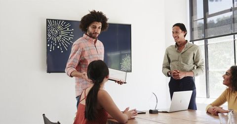 Happy colleagues celebrating workplace milestone in office