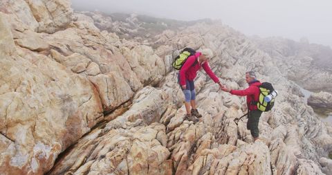 Senior Adventurers Climbing Rocky Mountain Terrain