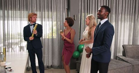 Multiracial friends celebrating wedding reception with confetti