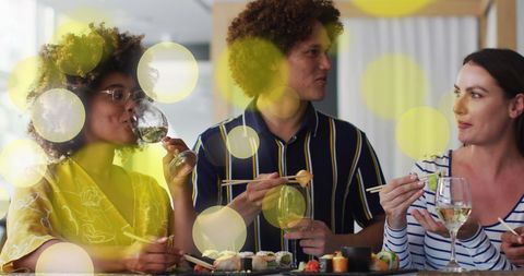 Diverse Friends Enjoying Sushi and Drinks with Ambient Lights