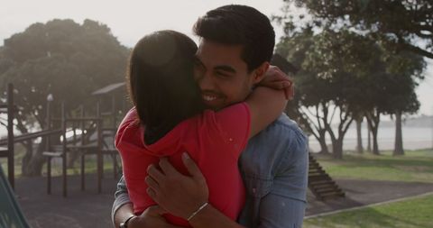 Romantic Couple Embracing on Sunny Day in Park