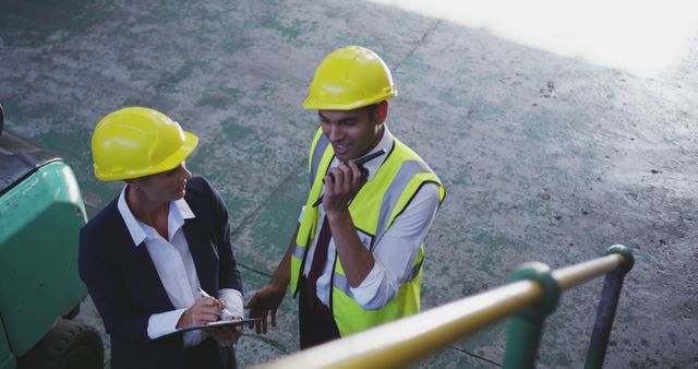 Warehouse Managers Discuss Logistics in Warehouse with Communication Devices - Download Free Stock Images Pikwizard.com