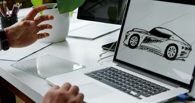A professional setting features a laptop displaying a car design sketch, with copy space. A person's hand gestures during a creative discussion or presentation, emphasizing the collaborative nature of design work.