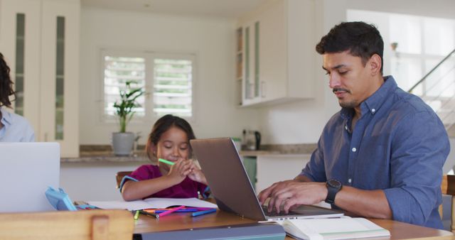 Father working on laptop while daughter doing homework at home - Download Free Stock Images Pikwizard.com