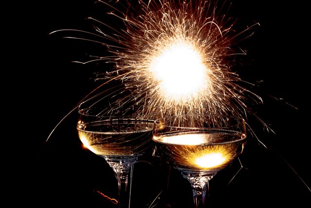 Sparkler Lighting up Two Wine Glasses with Glowing Celebration - Download Free Stock Photos Pikwizard.com