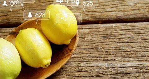 Fresh Lemons in Wooden Bowl with Overlayed Social Media Icons