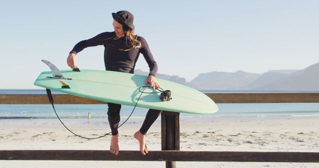 Female Surfer Prepares Surfboard by Beach - Download Free Stock Images Pikwizard.com