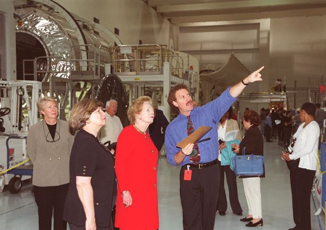 The attention of Lady Margaret Thatcher, former Prime Minister of Great Britain, is directed to one of the modules in the Space Station Processing Facility. Lady Thatcher is touring KSC. Accompanying her is JoAnn H. Morgan (left), director, External Relations and Business Development, at the Center